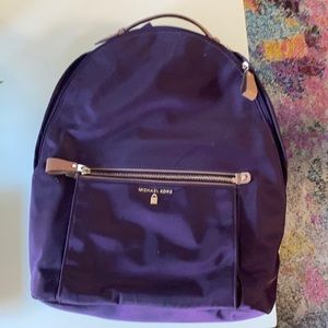 Purple MK Rhea’s backpack